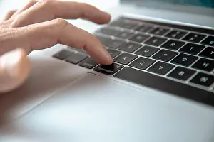 Input Prints: close up. man pressing the command key on his laptop