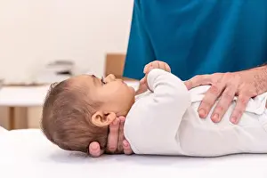 Examine Prints: Close-up photo of an unrecognizable doctor examining baby in office