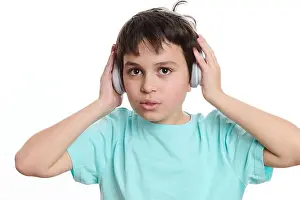 Back To School Prints: Close-up portrait handsome teenage boy putting on wireless headphones