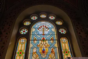 Rosette Prints: Close-up shot of a stained glass window featuring a menorah at the center
