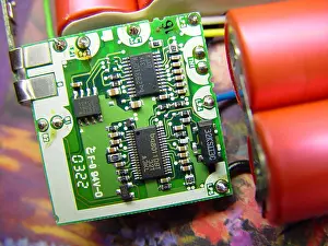 Components Prints: A close-up view of a laptop battery charger circuit board