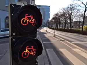 Traffic Light Prints: Close-up view of red traffic light for bicycles on cycling path next to a road in the downtown of Vienna