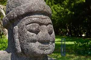 Korea Prints: Close-up view of the textured basalt face of a Jeju dolhareubang statue near Pyoseon Beach