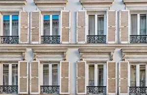 Shutters Prints: Close-up view of traditional French windows with open wooden shutters