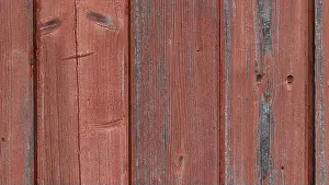 Flooring Prints: A close-up view of weathered wooden planks with a reddish hue