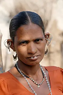 Maturity Prints: Close-up of a woman wearing traditional jewelry. Bhil Tribe. Rural faces of India
