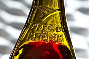 Rhone Prints: Close view on the glass relief label on a bottle of French Cotes du Rhone red wine