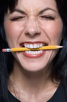 Eyes Prints: Close up of woman biting pencil