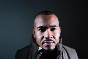 Worry Prints: Close up of a young Hispanic man with a mustache and beard posing MODEL RELEASED