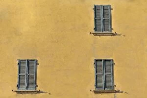 City Collection: Closed green windows on yellow wall of old house in Florence city, Italy