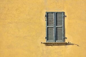 Images Dated 18th July 2017: Closed green windows on yellow wall of old house in Florence city, Italy