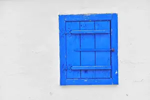 City Prints: Closed vintage blue window on white wall of old house in romania