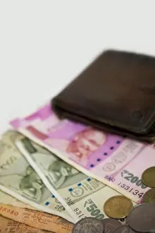 Earn Prints: Closeup of brand new colorful Indian currency bank notes of 5, 10, 500 and 2000 rupees