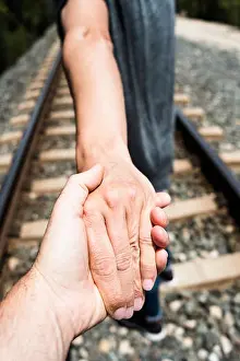Cruising Prints: closeup of the hand of a man holding the hand of another man