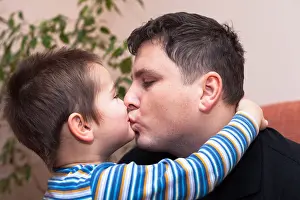 Fatherhood Prints: Closeup of happy father kissing his child boy