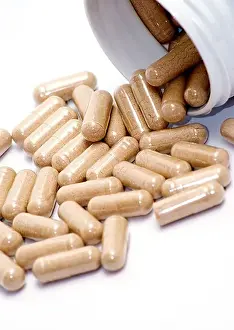 Capsules Prints: Closeup image of brown pills - roughage on the white background