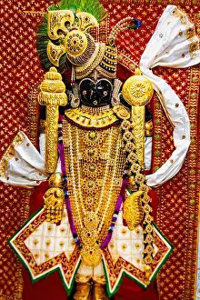 Gujarat Prints: closeup of intricately decorated hindu god dwarkadhish statue in golden attire