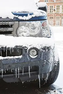 Difficulty Prints: Closeup of a land rover covered in snow and ice