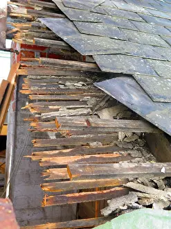 Turret Prints: Closeup of old slates and broken wooden supports at roof replacement project