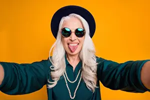 Childish Prints: Closeup photo of cool crazy white haired granny lady make selfies feel young stick tongue out mouth wear green shirt