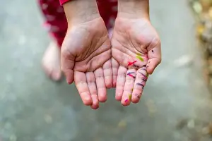 Acceptance Prints: Closeup photo looking down at a small child's hands (white)