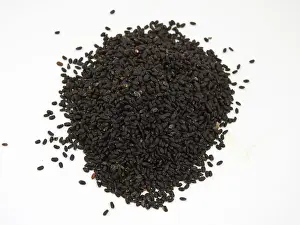 Calcium Prints: Closeup of pile of black chia seeds, Salvia hispanica on white background
