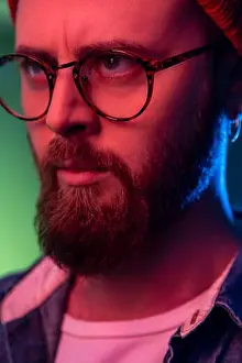 Self Assured Prints: Closeup portrait of strict bossy bearded male in glasses looking to side space with serious attentive face