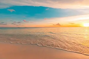 Closeup sea sand beach. Panoramic beach landscape. Inspire tropical beach seascape horizon. Orange and golden sunset sky calmness tranquil relaxing
