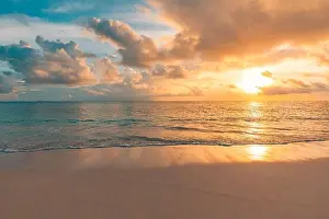 Closeup sea sand beach. Panoramic beach landscape. Inspire tropical beach seascape horizon. Orange and golden sunset sky calmness tranquil relaxing