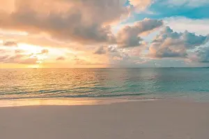 Closeup sea sand beach. Panoramic beach landscape. Inspire tropical beach seascape horizon. Orange and golden sunset sky calmness tranquil relaxing