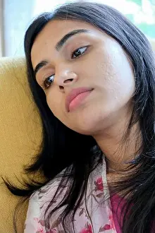 Piercing Prints: A closeup shot of an Indian lady with a piercing on her nose at home
