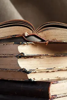 Book Cover Prints: Closeup of stack of old books on canvas background