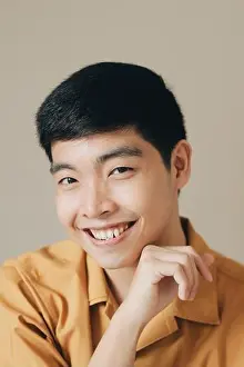 Chin Prints: Closeup vertical portrait of a cute charming man tenderly touching his chin and smiling happily