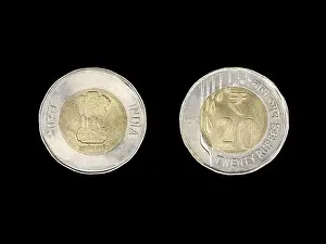 Invest Prints: closeup of a vintage metallic indian 20 (twenty) rupees coin made of gold and silver colored metal