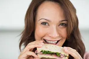 Lunch Break Prints: Closeup of a woman eating sandwich