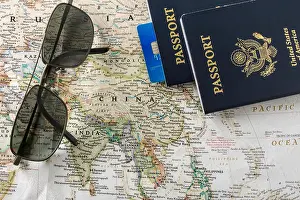Citizenship Prints: Closeup of a world map featuring mostly Asia with passports and a credit card sitting on top