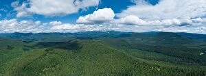Aerial Landscape Collection: Clouds drift through a blue sky over and endless forest, near Mount Hood, Oregon