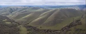 Clouds drift across peaceful green hills and valleys in the tri-valley area in Northern California