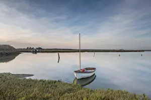 Small Boat Prints: Clouds and a small boat reflected in the still water at Walton & Frinton Yacht Club