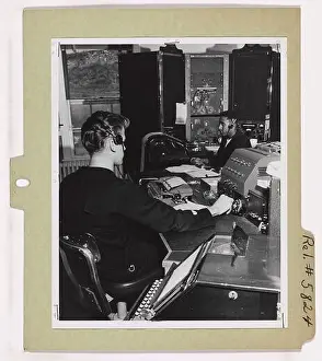 Operators Prints: A Coast Guard radioman works in the main operating room at the Coast Guard Radio Station NMQ on Point Vicente
