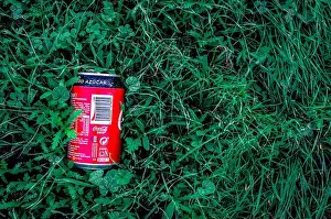 Careless Prints: A can of Coca-cola Zero on green grass. Disrespect for the environment. Copy space