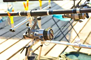 Bait Prints: Coil rod, which is mounted on the jetty for fishing on a sunny day