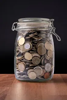 Capitalism Prints: Coins inside a glass container full of money