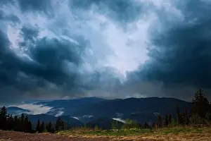 Low Clouds Prints: Cold cloudy rainy weather over low hills covered with spruce evergreen forests in Rhodope Mountains against backdrop of