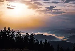 Low Clouds Prints: Cold cloudy rainy weather over low hills covered with spruce evergreen forests in Rhodope Mountains against backdrop of