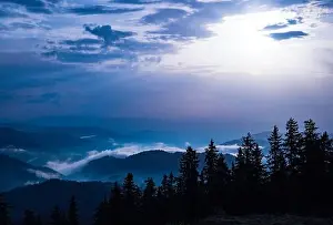 Low Clouds Prints: Cold cloudy rainy weather over low hills covered with spruce evergreen forests in Rhodope Mountains against backdrop of