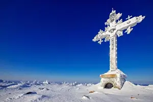 Cold landscape worship cross mountain with blue sky Kemerovo region Russia in winter forest