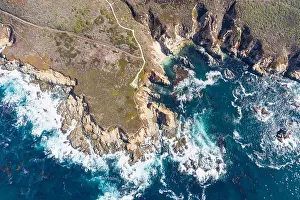 The cold, nutrient-rich waters of the North Pacific Ocean wash against the rocky and scenic coastline of Northern California not far from Monterey