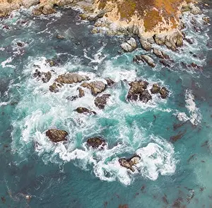 The cold, nutrient-rich waters of the North Pacific Ocean wash against the rocky and scenic coastline of Northern California not far from Monterey