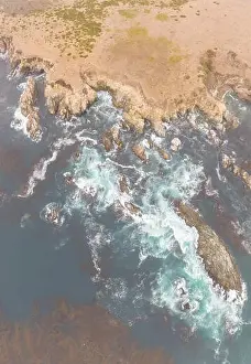 The cold, nutrient-rich waters of the North Pacific Ocean wash against the rocky and scenic coastline of Northern California not far from Monterey